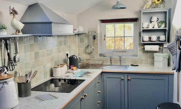 fully equipped kitchen with dishwasher ,oven and hob ,microwave and fridge .